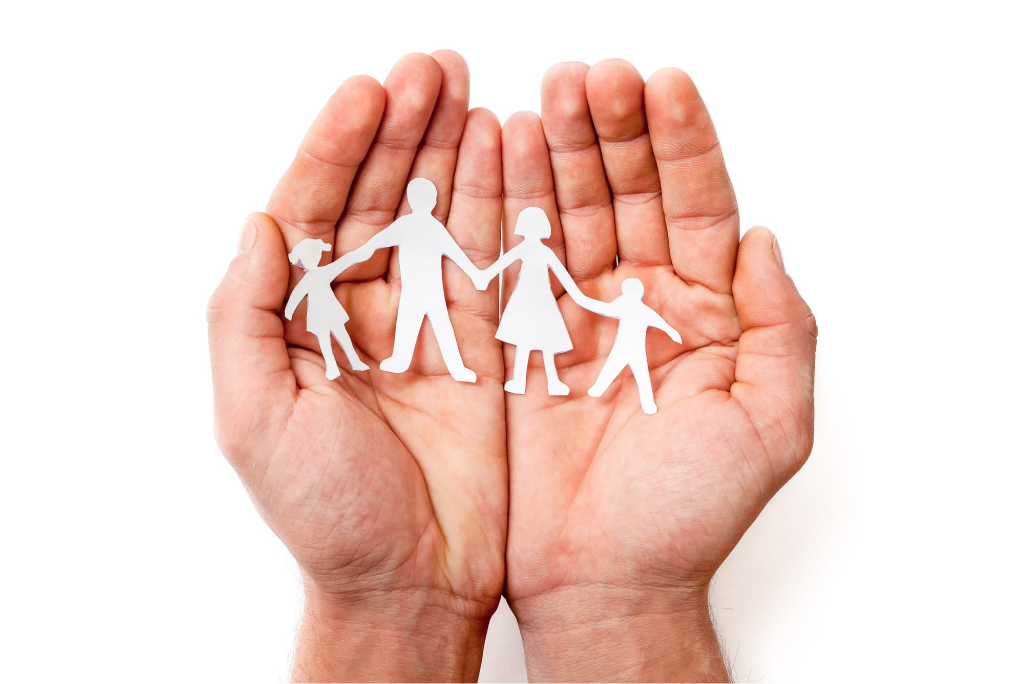 Hands holding a paper family